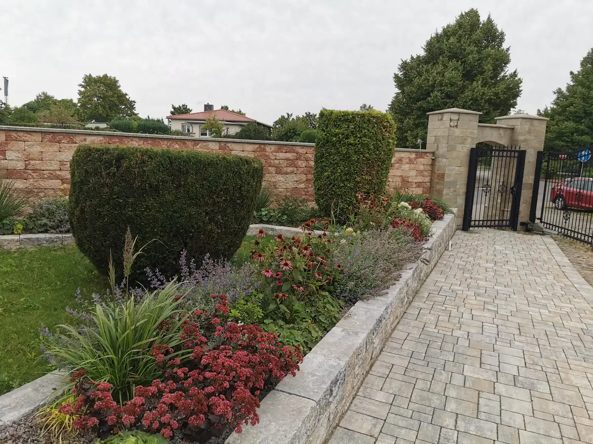 rundum Galabau GmbH – Beet mit Gartenweg und Mauer